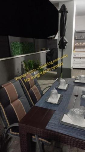 a room with a table with a couch and a dining room tableablish at VOYAGE CUBIC Adults Only in Sibiu
