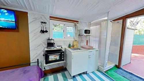 a small kitchen with a stove in a caravan at Apartaments Kandy 2 in Calafell