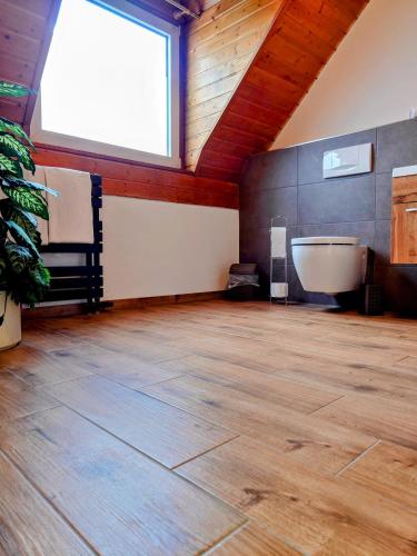 a large bathroom with a tub and a large window at Hotel zur Schlemmerscheune in Weilerbach