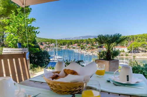 a table with a basket of bread on top of it at Apartments Vila Jelka in Vrboska