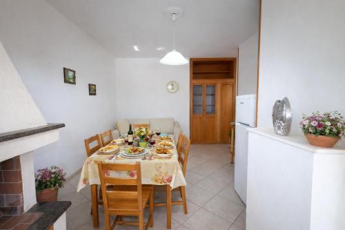 a kitchen and dining room with a table and chairs at Rosa Fronte Mare in Torre Mozza
