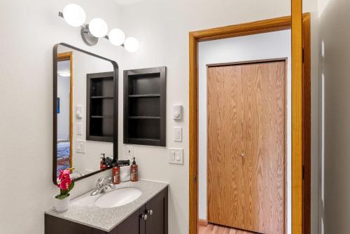 a bathroom with a sink and a mirror and a door at 08 Lodge in Hood River
