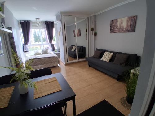 a living room with a couch and a table at Studio Benal Iris in Málaga