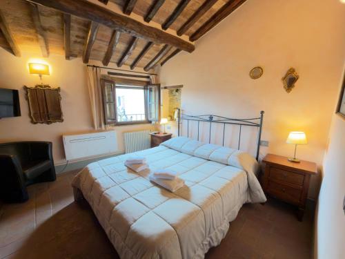 a bedroom with a large bed and a television at Le Torri View Apartment - San Gimignano in San Gimignano
