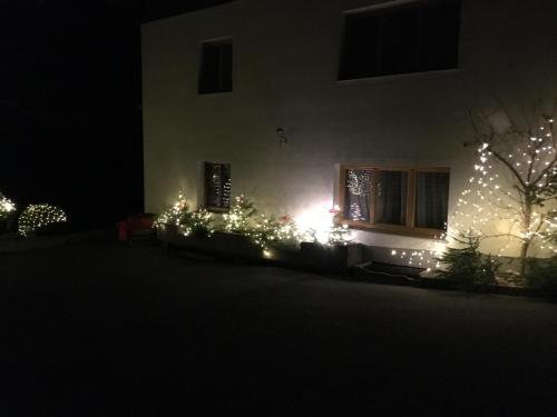 a house decorated with christmas lights and a window at Oberhub am Kleinsonnberg in Taxenbach