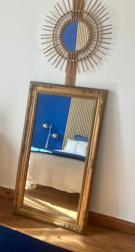 a mirror sitting on a table in a room with a mirror at La Cachette de Beaumont in Marsais