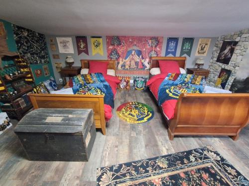 a bedroom with two twin beds and a rug at Un Air de Poudlard in Bogny Sur Meuse