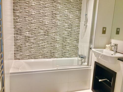 a bathroom with a shower and a sink at 2-Bedrooms Modern Apartment next to Velodrome, Lounge, Balcony, Parking, ABBA in London