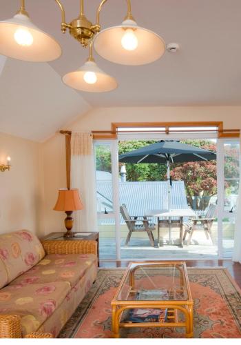 a living room with a couch and a table with an umbrella at Seaport Village in Russell