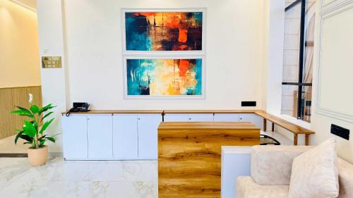 a living room with a table and a painting on the wall at Mandhata Riverview Palace in Mortakka