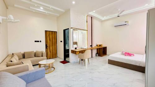 a hotel room with a bed and a couch at Mandhata Riverview Palace in Mortakka
