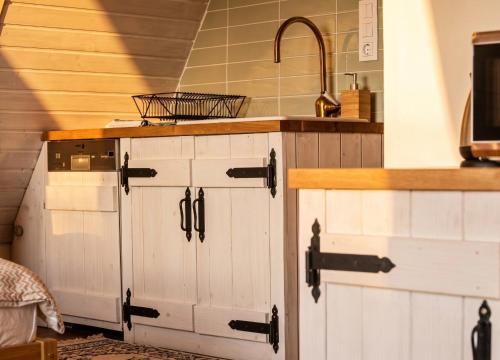 a kitchen with a sink and a counter with a sink at Kamonkő Panoráma Kuckó in Szigliget