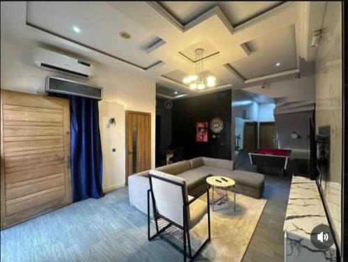 a living room with a couch and a table at Jolie Homes in Lekki