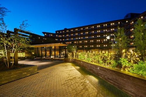 a building with a garden in front of it at Lodge Park Hotel & Spa in Soldeu