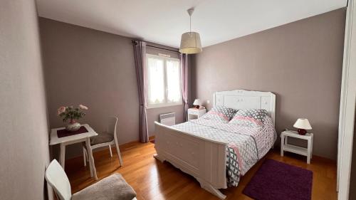 a bedroom with a white bed and a window at Les Ptis Bregeons in Talmont