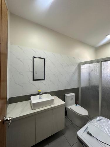 a bathroom with a sink and a toilet at Jens Residence villa in Bamban
