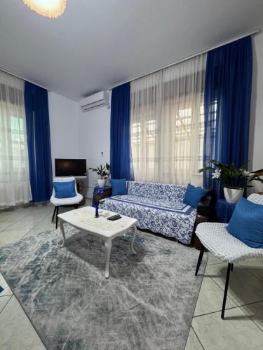 a living room with a couch and a table at Hotel Kaduku in Shkodër