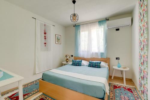 a bedroom with a bed and a window at Bujtina Ethan Perondi - Private Villa Swimming Pool in Kuçovë