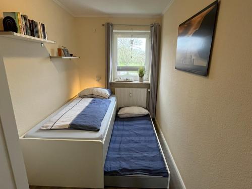 a small room with two beds and a window at Wattenküste in Büsumer Deichhausen