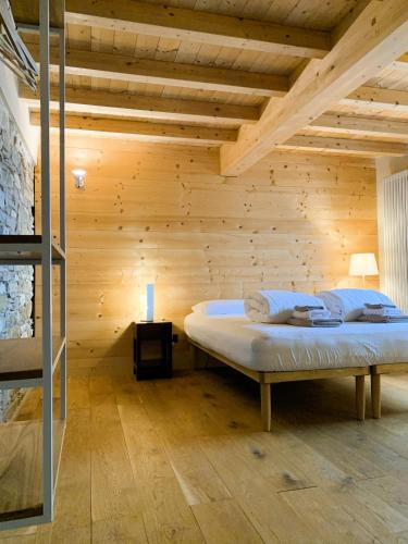 a bedroom with a bed in a wooden room at Le Spine B&B sulla Via Francigena in Berceto