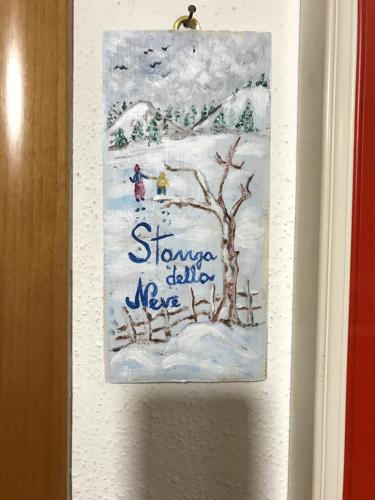 a painting of a winter scene on a door at B&B Magna Grecia in Crotone