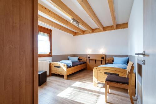 a room with two beds and a table at Dieboldshof in Neuried