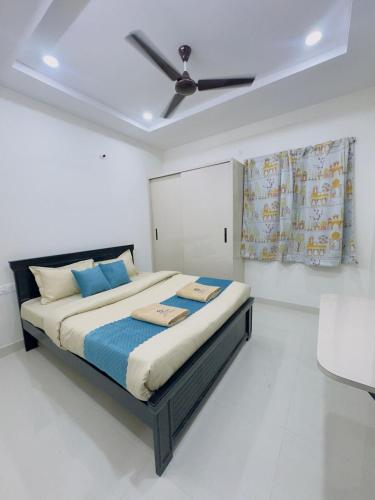 a bedroom with a bed with a ceiling fan at B2 601 1BHK Flat by Charter Stays in Hyderabad