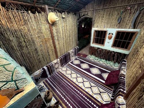 an inside view of a bird house with a table at Iqama Al-Nakhlah in Ghardaïa