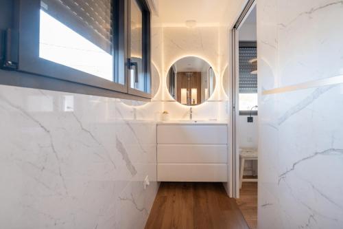 a bathroom with a sink and a mirror at Maison Desmathi in Saint-Pierre-Quiberon