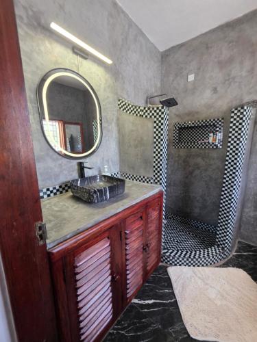 a bathroom with a sink and a mirror at Daystar Villa in Watamu