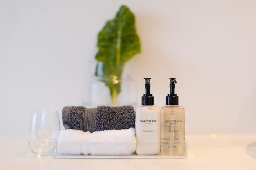 two bottles ofodorizers sitting on a counter with towels at Barrington's in Plettenberg Bay