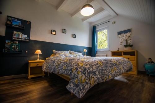 a bedroom with a large bed and a window at Le nid du Curtil - Chambre d'hôtes in Rougegoutte
