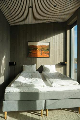a bedroom with a large bed with white sheets at Modern One-Bedroom Apartment in Henningsvær in Henningsvær