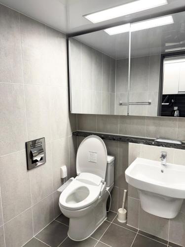 a bathroom with a toilet and a sink at Yangyang Surfing Beach 18 in Saetchak