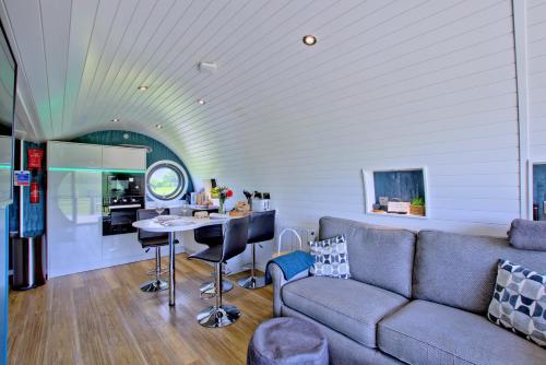 a living room with a couch and a table at Hollins Farm - Dog Friendly, Self Catering Holiday Lodges in Knaresborough