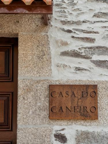 a sign on the side of a stone building at Casa do Caneiro in Vila Real