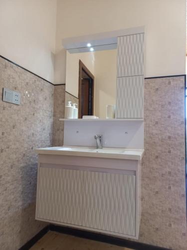a bathroom with a sink and a mirror at Naz in Lerik