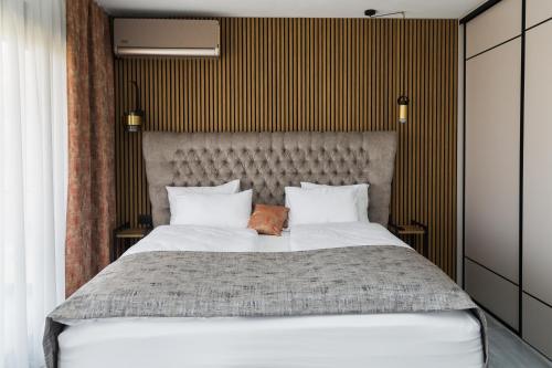a bedroom with a large bed with two pillows at Villa Bartula in Bar