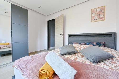 a bedroom with a large bed with two pillows at Le pacifique in Schiltigheim