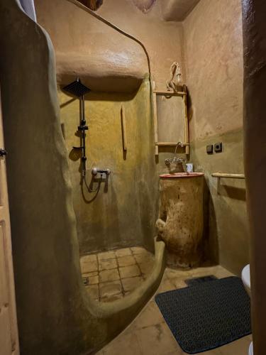 a dirty bathroom with a shower and a sink at Heritage House Skoura in Skoura