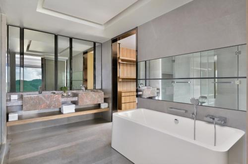 a bathroom with a large tub and two sinks at Kathmandu Marriott Hotel in Kathmandu