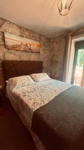 a bedroom with a bed and a window at Casa da Avo in Geres