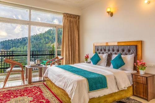 a bedroom with a bed and a large window at Vamitag Inn in Shimla