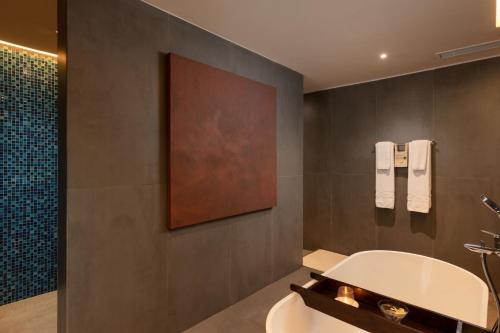 a bathroom with a sink and a bath tub at Jetwing Sea in Negombo