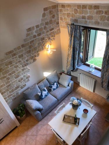 a living room with a couch and a table at Sunset house in Castiglioncello