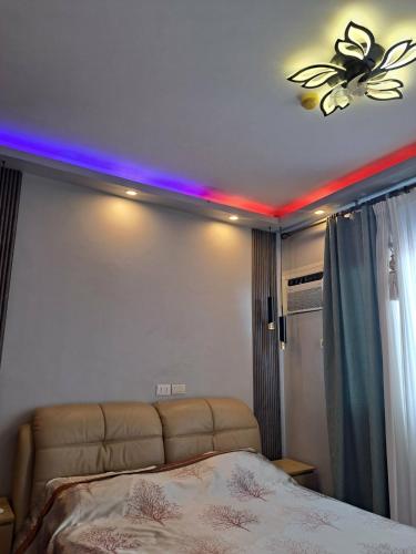 a bedroom with a bed and a ceiling with lights at Royal oceancrest mactan in Mactan Island