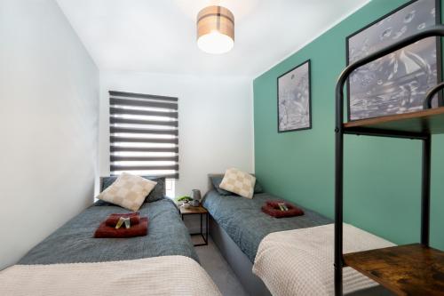 a bedroom with two beds and a bunk bed at 3 bed house, Free parking 9ppl in Pleasley