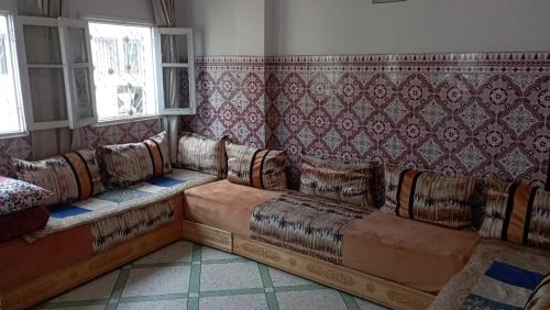 a living room with couches in a room at appartement bab boujloud in Fez