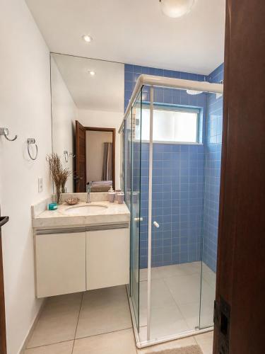 a bathroom with a sink and a glass shower at Shamballa - luxury house and apartments in São Miguel do Gostoso