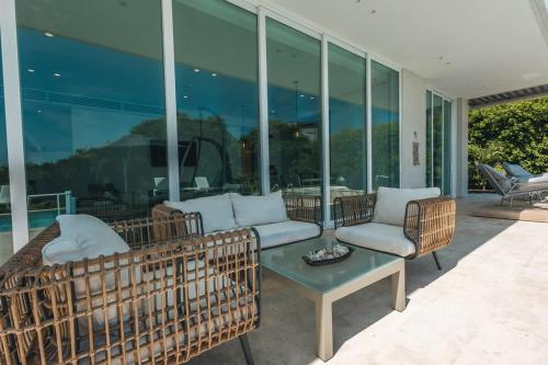 a living room with two couches and a table at Tropical villa w pool & dock access u501 in Barú